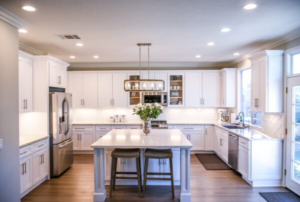 Modern kitchen is shown with recessed lighting, under cabinet lighting and a feature pendant light.